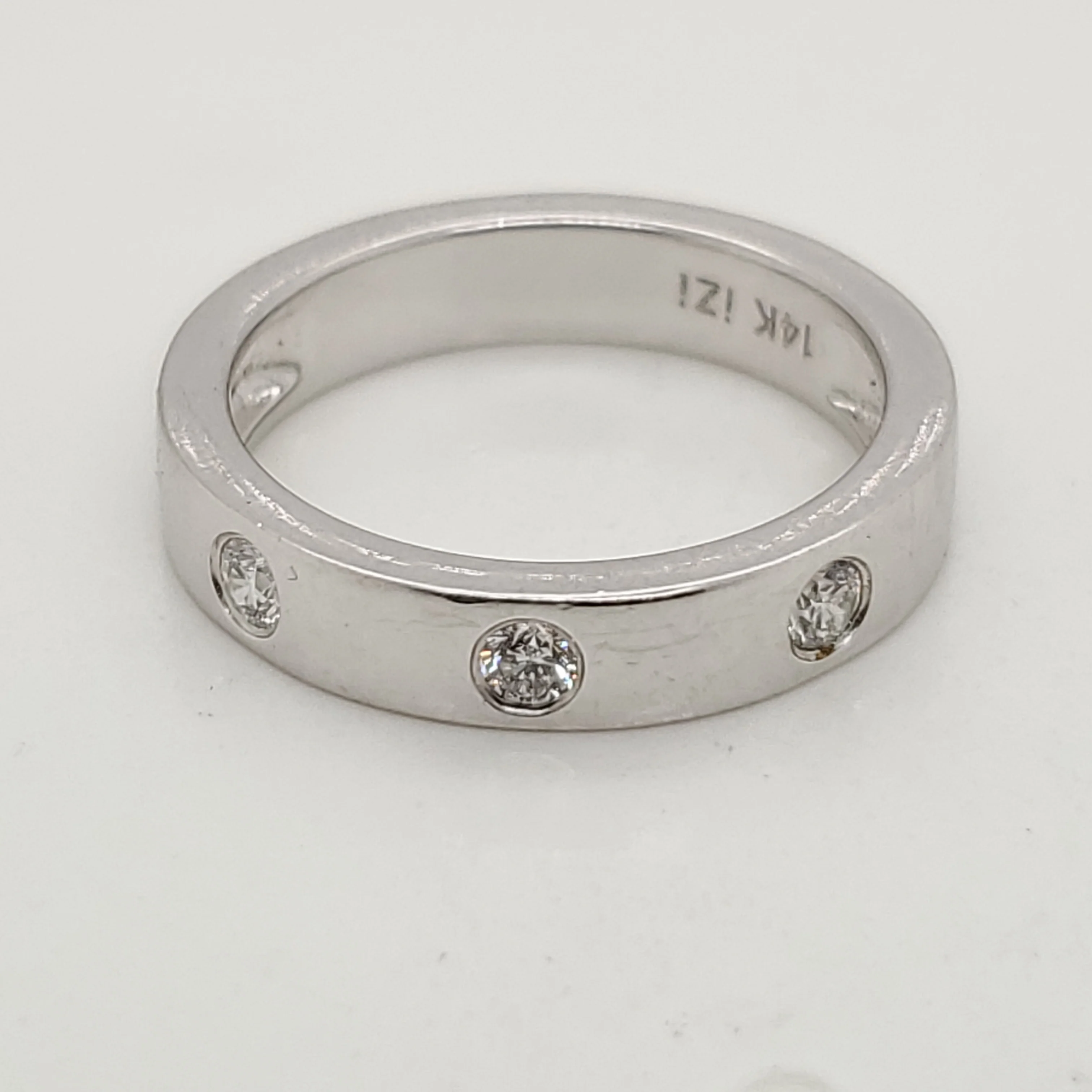 14kt white gold bezel set diamond band.